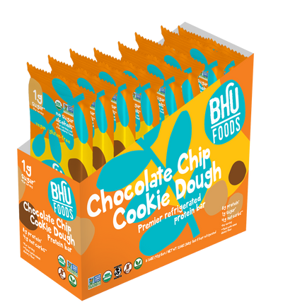 An open caddy box of Bhu Foods Premier Refrigated Chocolate Chip Cookie Dough Bar with 8 individually wrapped bars of the same flavor standing vertically.