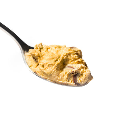 A close-up image of a spoonful of chocolate chip protein cookie dough.