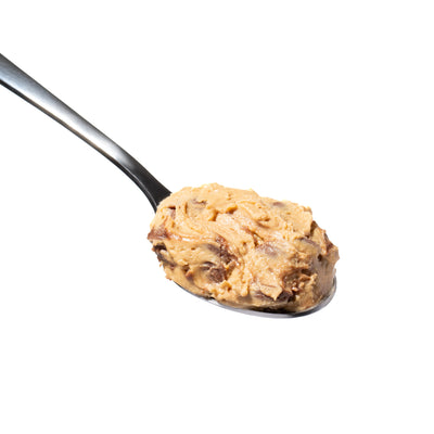 A close-up image of a spoonful of peanut butter chocolate chip protein cookie dough.