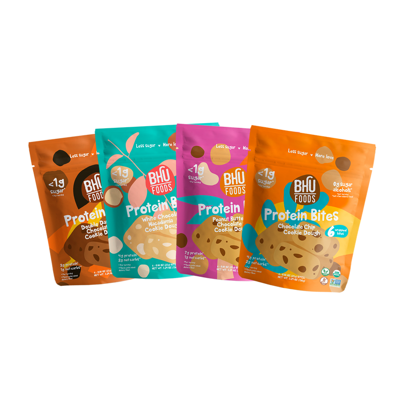 An assortment of four Protein Bites bags (5.29oz each). One bag of each flavor: Double Dark Chocolate Chip Cookie Dough, White Chocolate Macadamia Cookie Dough, Peanut Butter Chocolate Chip Cookie Dough and Chocolate Chip Cookie Dough.
