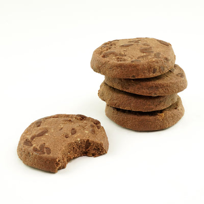 A close-up image of five unwrapped double dark chocolate protein cookies one partially bitten.