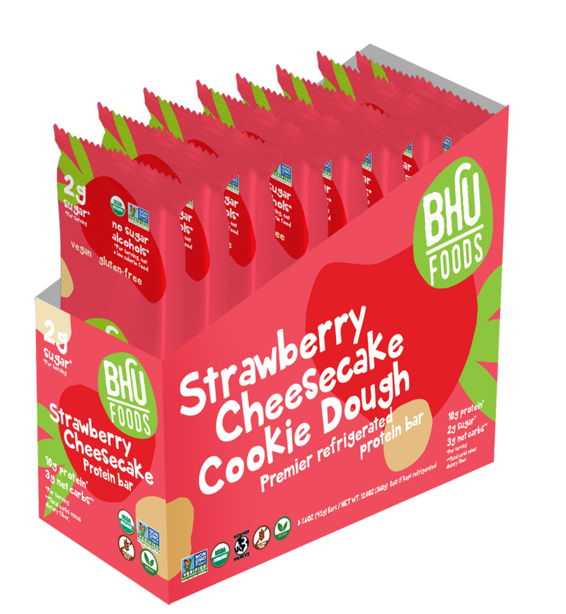 An open box of Strawberry Cheesecake Cookie Dough Premier Refrigerated Protein Bar with eight individually wrapped bars (1.6oz each) inside.