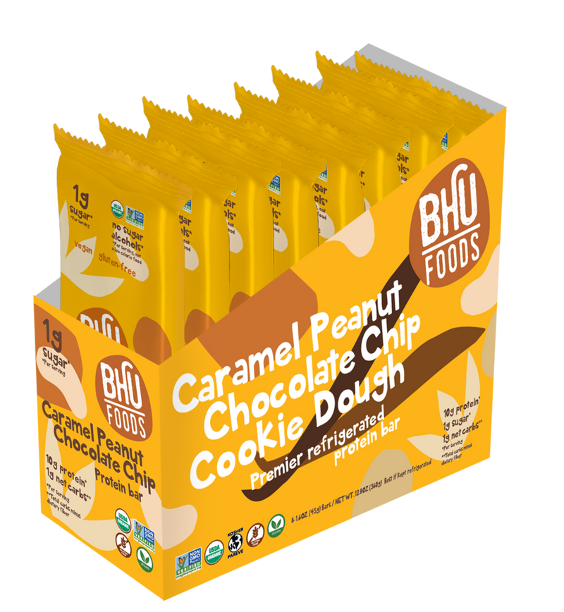An open box of Caramel Peanut Chocolate Chip Cookie Dough Premier Refrigerated Protein Bar with eight individually wrapped bars (1.6oz each) inside.
